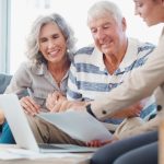 an elderly couple meets with a firendly young woman to preplan for their end-of-life arrangements.