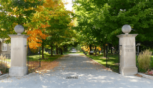 Front entrance of Woodlawn Memorial Park with the front gates and cement pillars