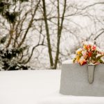 grave with flowers in the winter