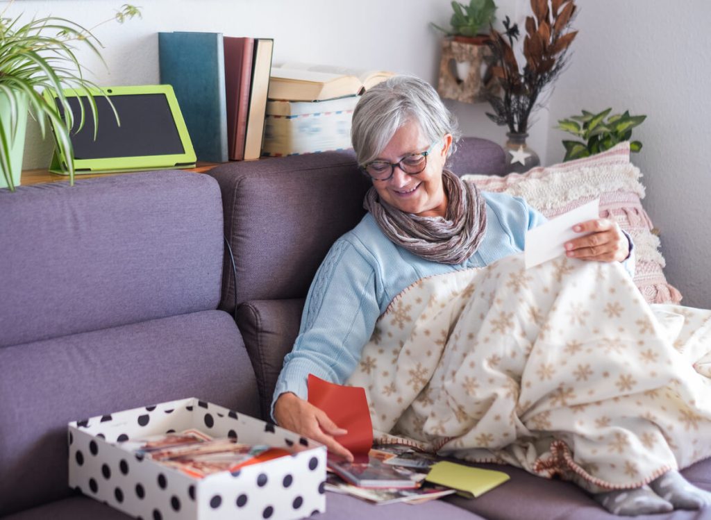 Older woman looking at a box of memories