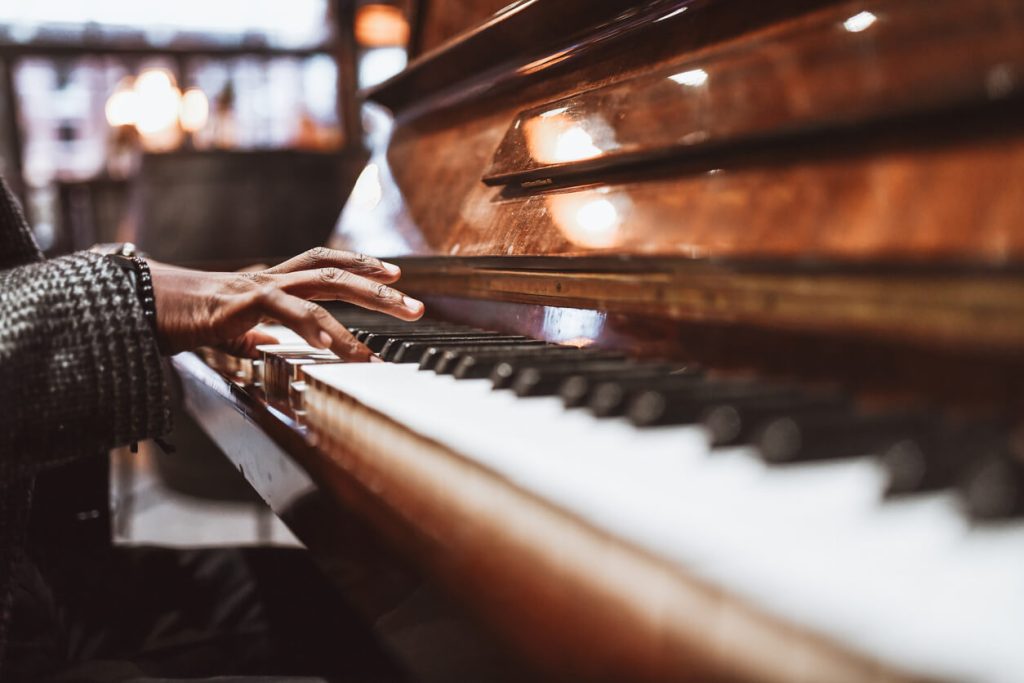 Older hands playing a piano