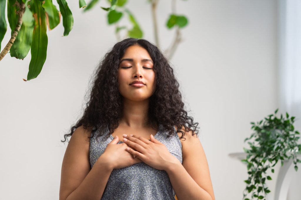 Woman with her hands on her heart meditating