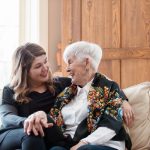 Two women sitting together smiling