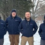 A photo of the grounds crew at Woodlawn Memorial Park, standing outside in winter.